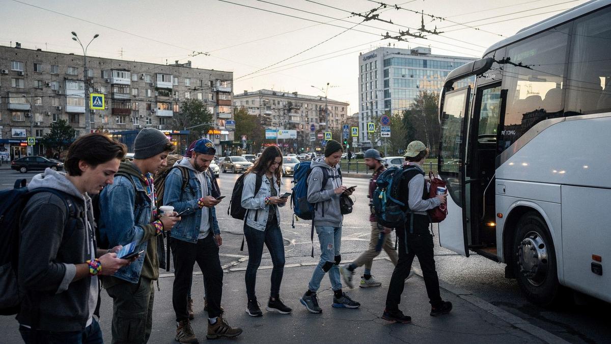 Young travelers with backpacks waiting at a bus departure point in Kyiv before a festival trip.